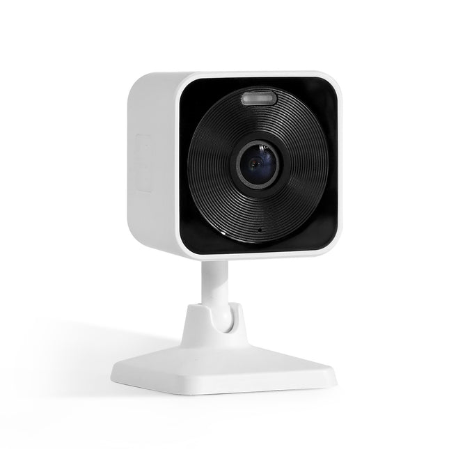 Small white security camera with black lens on a white background