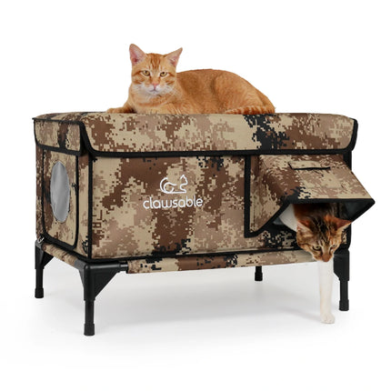 Two cats resting in insulated outdoor cat house with camouflage design, dual-entry for pets
