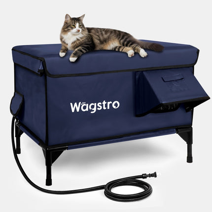 A cat lies on a navy blue Wagstro pet lift and crate system with a black hose coiled in front, photographed on a light gray studio background.
